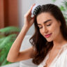 Woman practicing a healthy hair routine in Saraland AL with a scalp massager at home