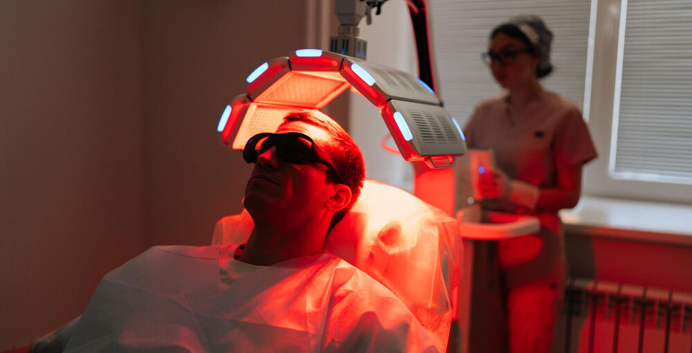 Man receiving red light treatment in Saraland AL for skin and muscle recovery