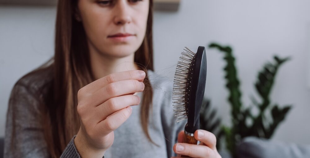 Stress-related hair shedding shown with visible thinning at the scalp
