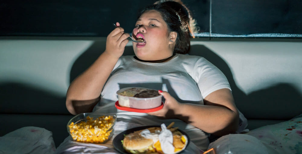 Person lying awake and eating at night struggling with poor sleep and weight loss challenges